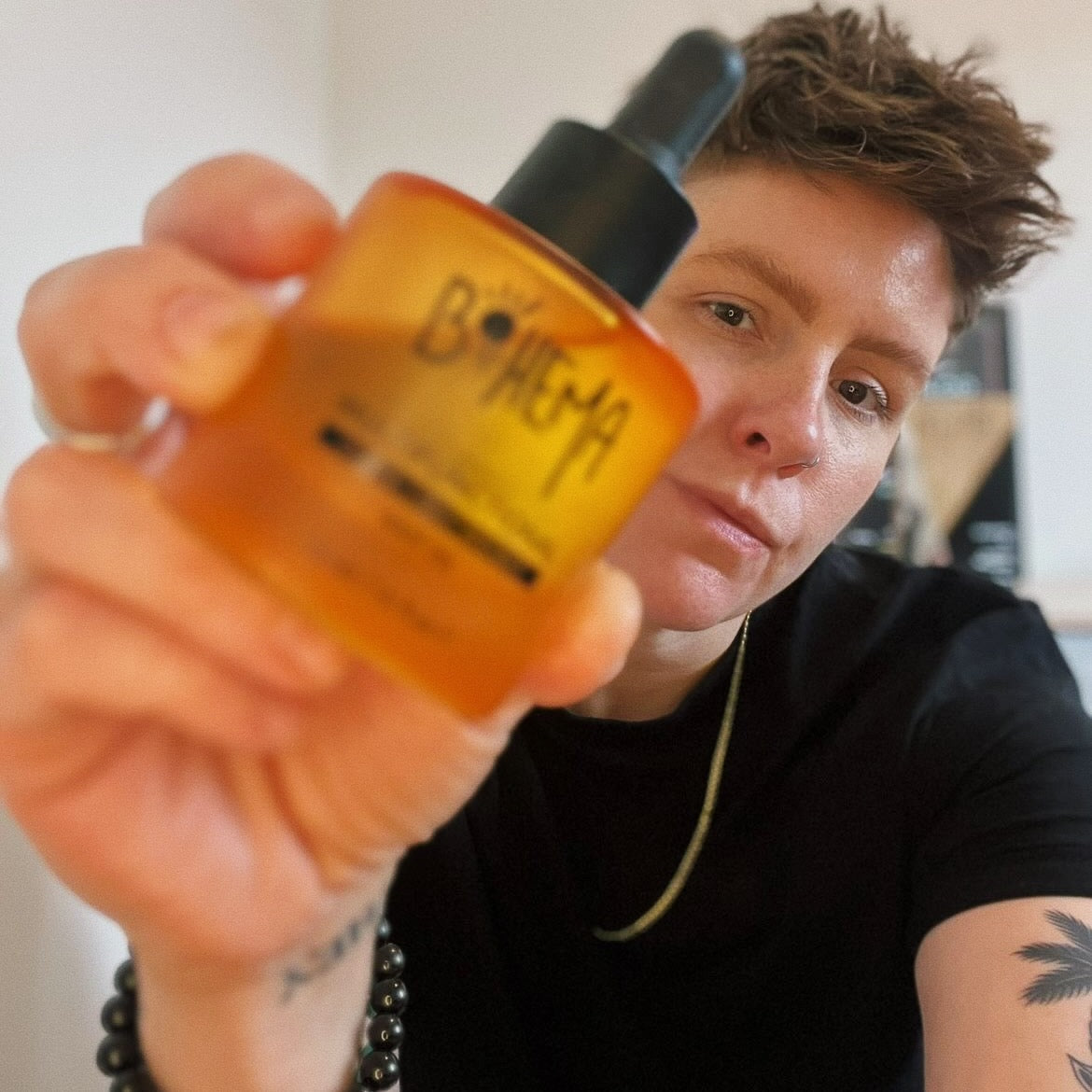 Picture of happy customer, holding BOHEMA HAIR Oil bottle