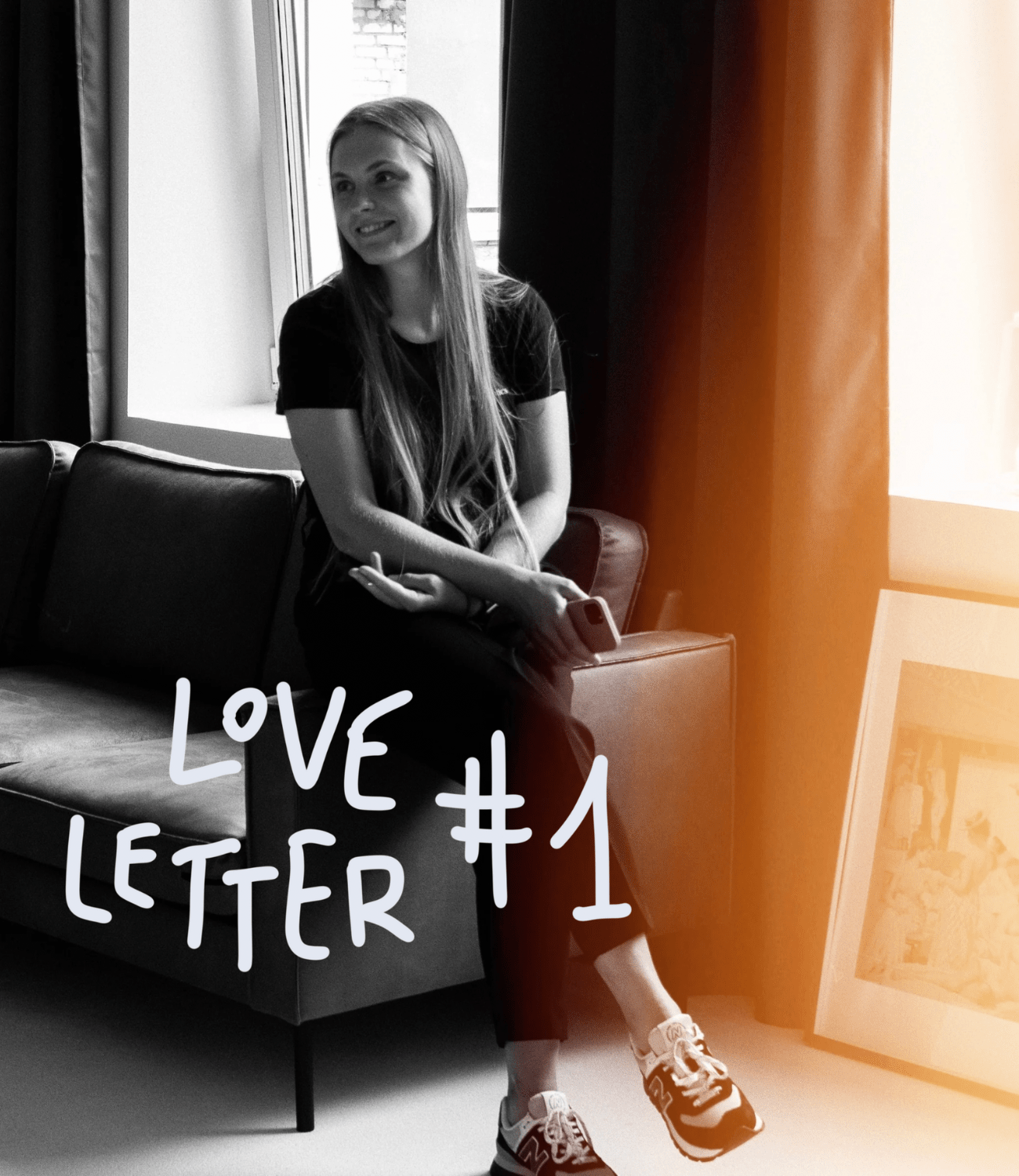 Woman with long hair relaxing on a sofa looking into the distance