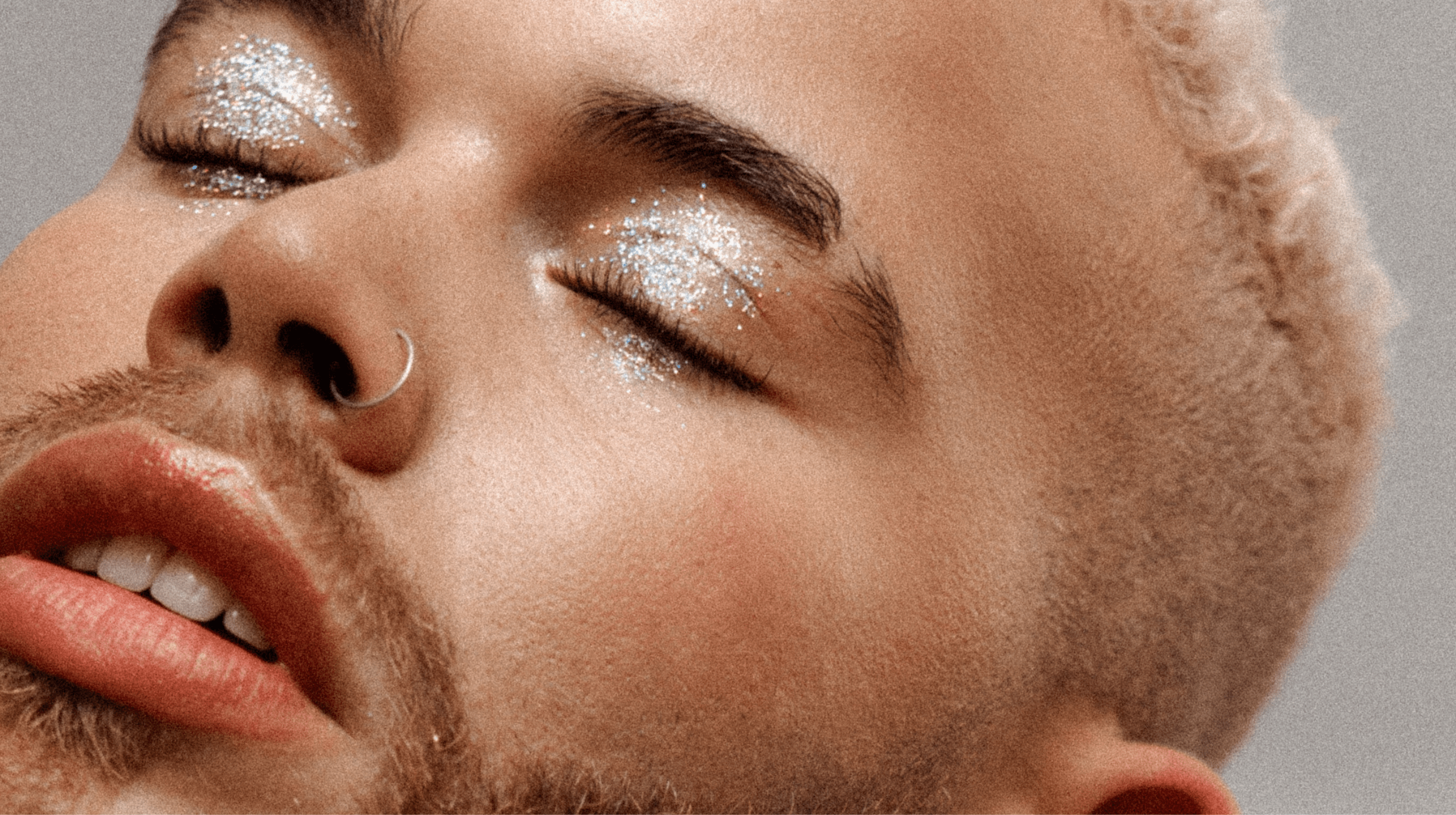 Man with blonde hair, beard and eye glitter